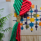 Handcrafted macrame bookmark in red, green, with a heart shape
