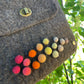 Close-up detail of felt handbag highlighting the natural Merino wool texture and artisanal finish.