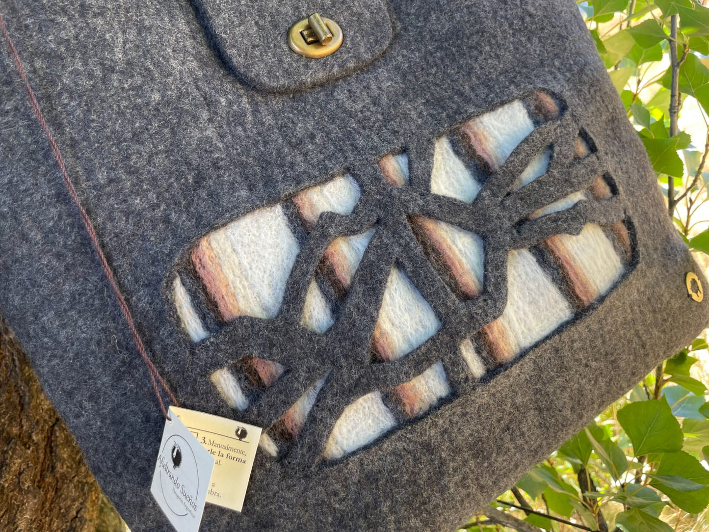 Close-up detail of felt handbag highlighting the natural Merino wool texture and artisanal finish. Made in Patagonia Argentina