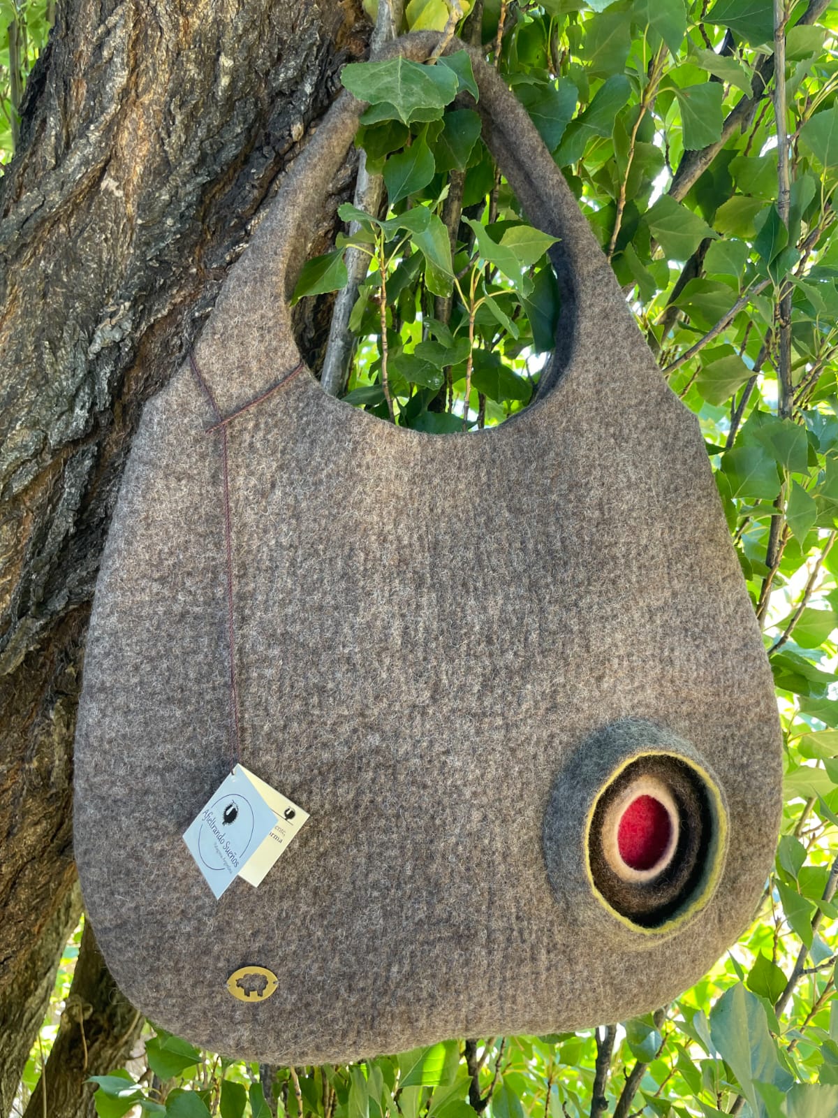 Interior view of handmade felt handbag showing soft Merino wool and minimalist Patagonia design.