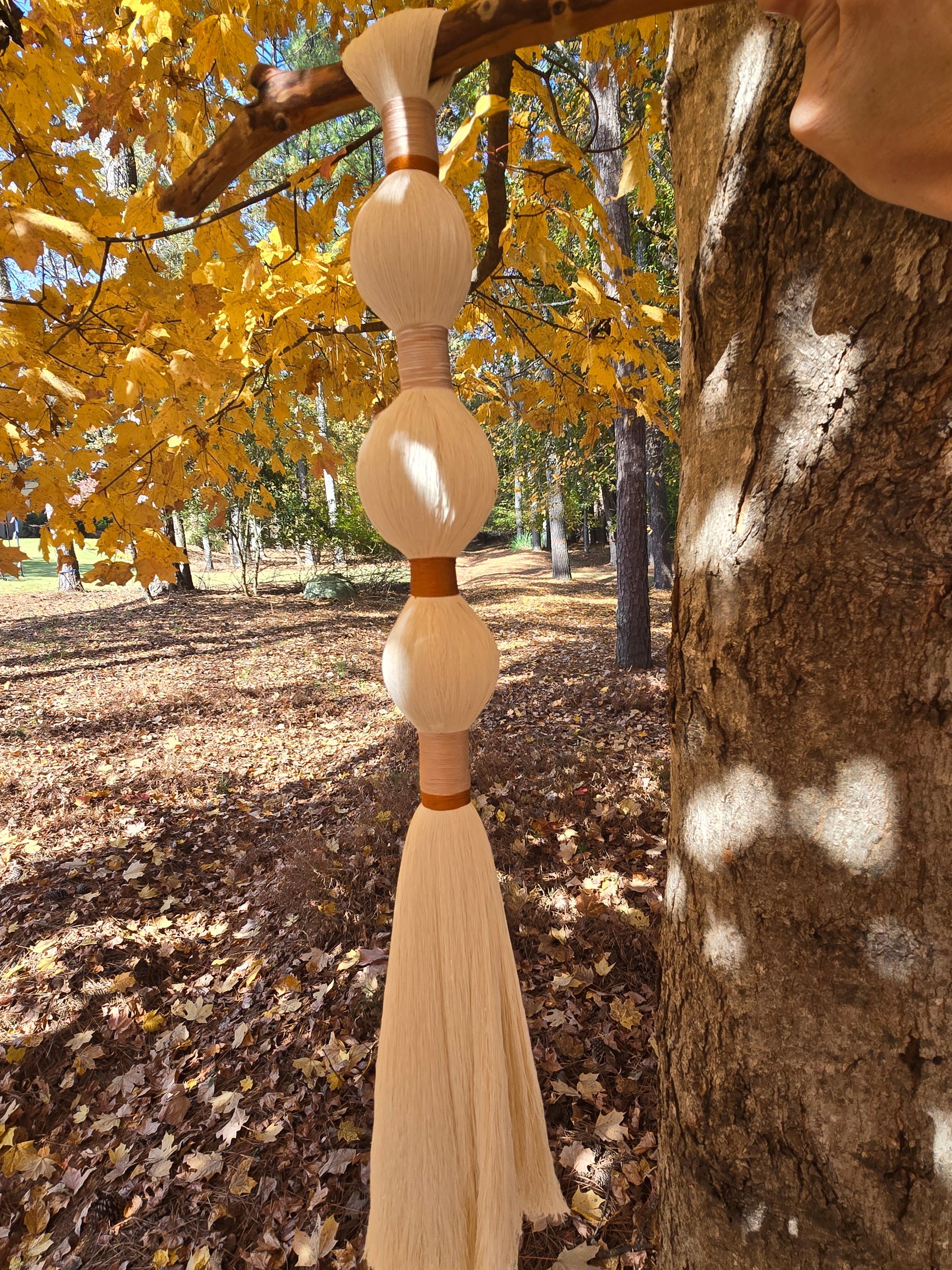 Handmade minimal wall hanging crafted with recycled cotton yarn and natural wood.