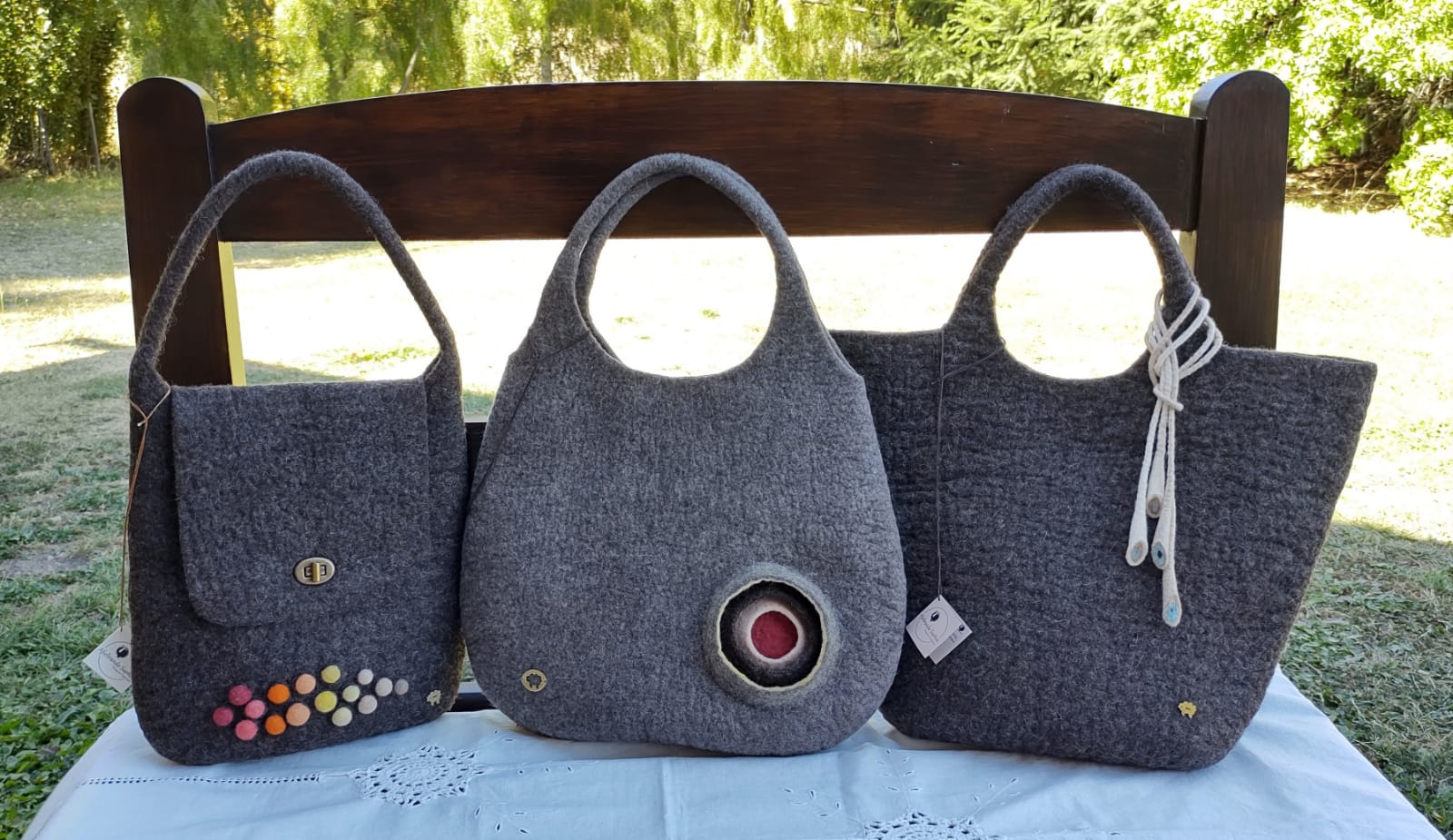 Side view of handmade Merino wool felt handbag showing soft texture and seamless craftsmanship.