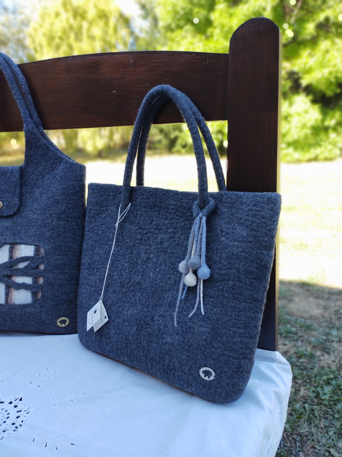 Side view of handmade Merino wool felt handbag showing soft texture and seamless craftsmanship.