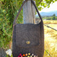 Handcrafted felt handbag styled as a sustainable fashion accessory – natural and timeless look.