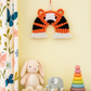 Handmade tiger rainbow wall hanging made of cotton cord and wool – perfect for nursery or kids room decor.