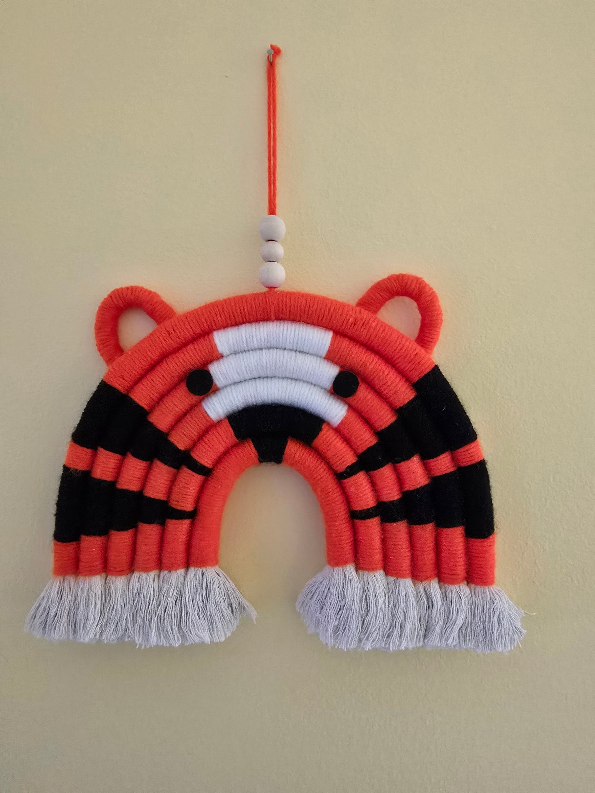 Tiger rainbow wall hanging displayed on a nursery wall – playful handmade decor for baby or child’s room.